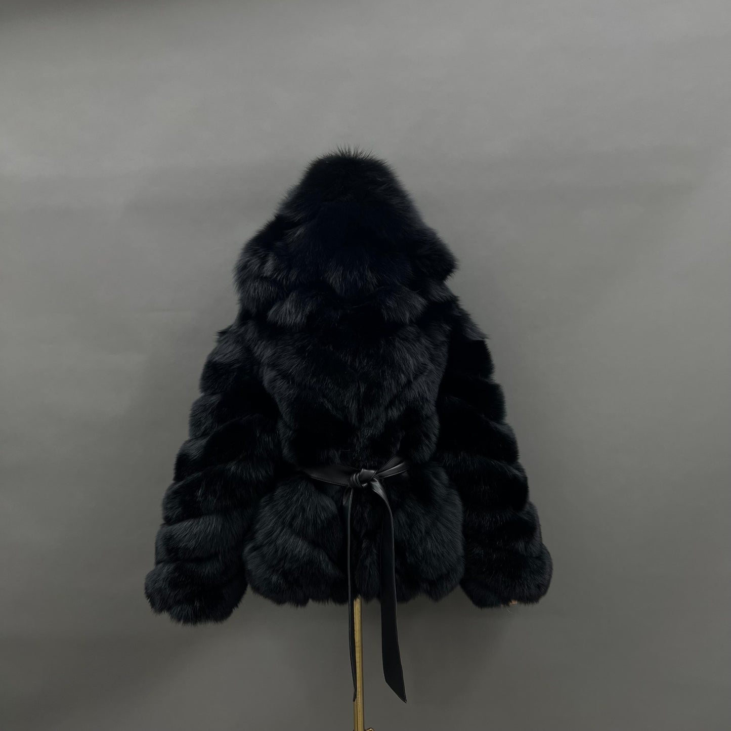 Black belted hooded fox fur jacket with sculpted chevron placement