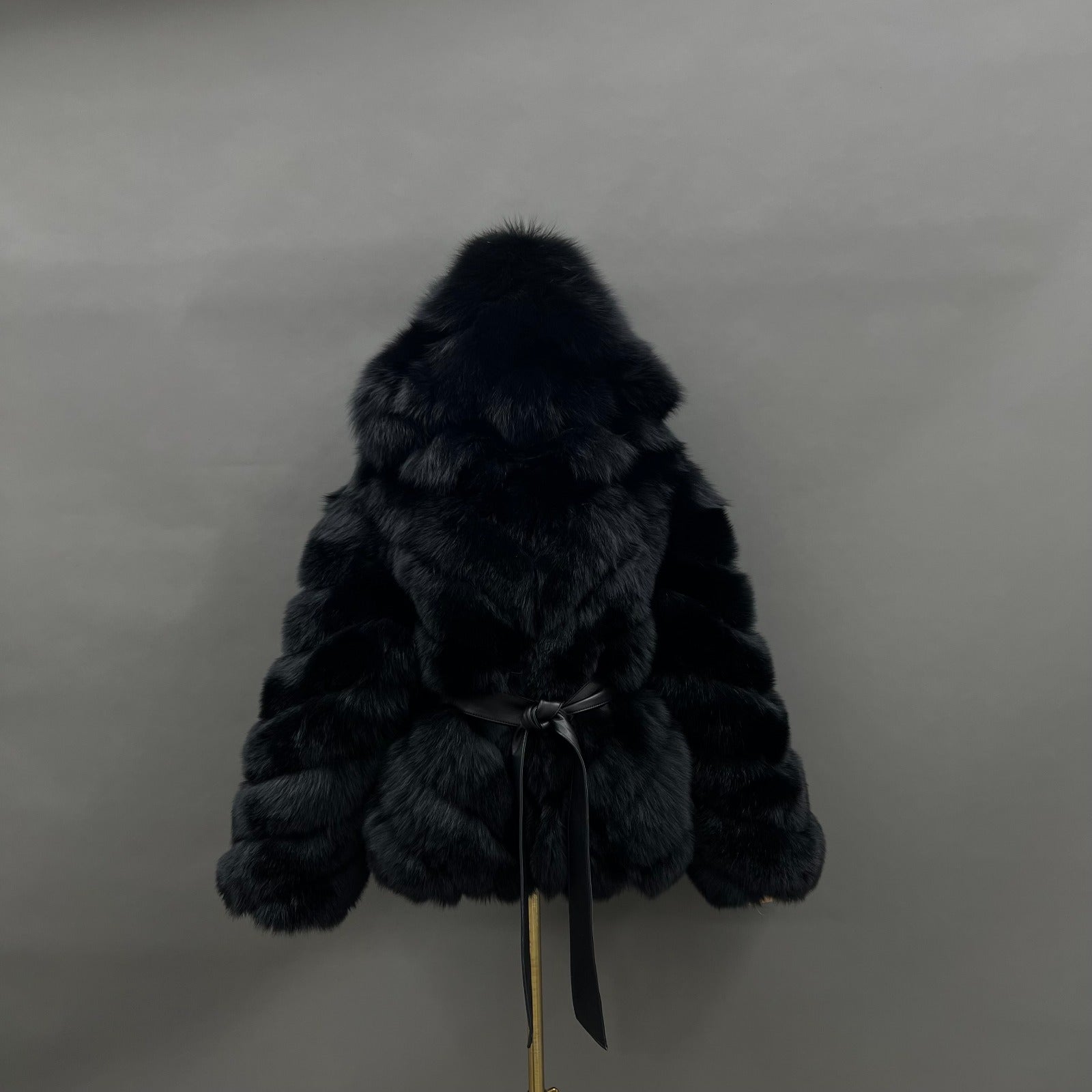 Black belted hooded fox fur jacket with sculpted chevron placement